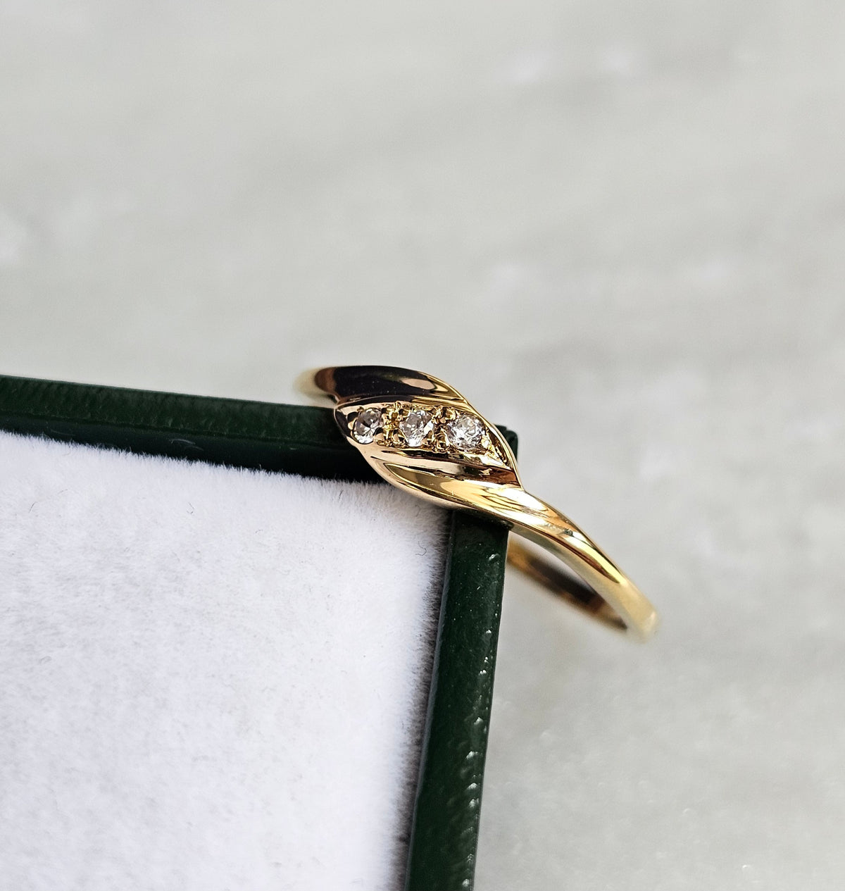 Bague vintage fine en or jaune, de style trilogie, sertie de trois pierres blanches, vue de profil